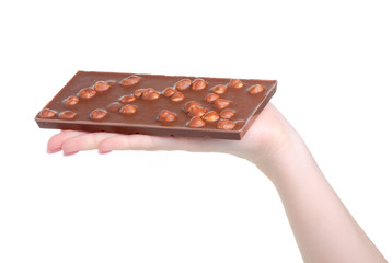 Chocolate bar with nuts in hand on white background isolation