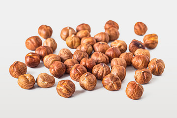 Heap of hazelnuts on white background