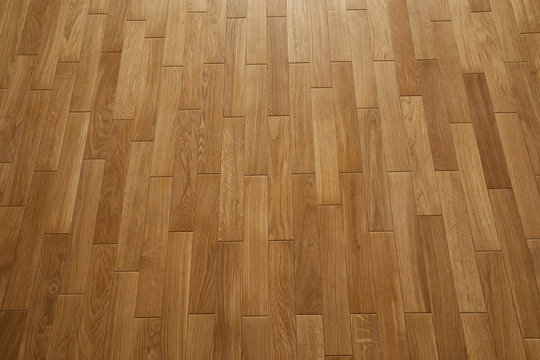Natural wooden texture. New oak parquet. Wooden laminate floor boards background image. Polished oak pattern.