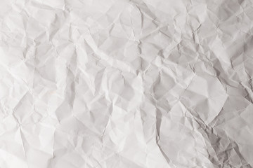 Crumpled white paper background.