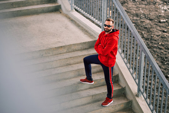 Attractive sportsman posing in urban modern environment. 