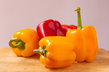 Red and yellow fresh sweet peppers on white background. Healthy ingredients, summer food