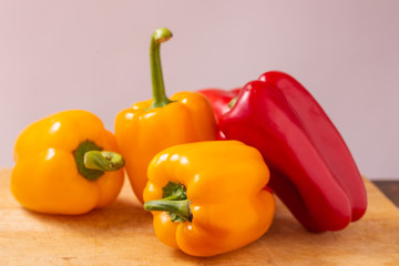 Red and yellow fresh sweet peppers on white background. Healthy ingredients, summer food