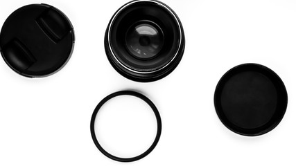 Lens and filters for professional cameras on a white background. View from above .