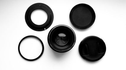 Lens and filters for professional cameras on a white background. View from above .