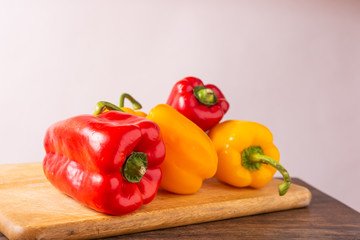 Red and yellow fresh sweet peppers on white background. Healthy ingredients, summer food