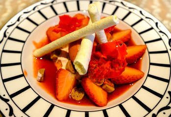 Strawberry dessert with milk sticker on a white dish set