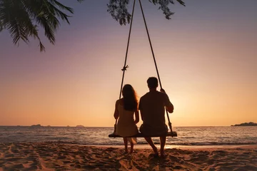 Poster honeymoon travel, silhouette of romantic couple on sunset  beach, tropical holidays near the sea, man and woman together on vacation © Song_about_summer