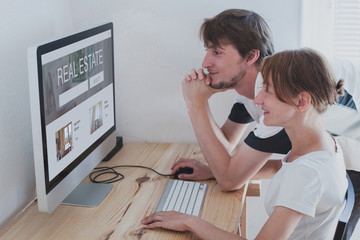 couple choosing real estate, rent new home for young family online