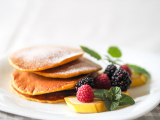 Pumpkin pancakes with raspberries mint and blackberries