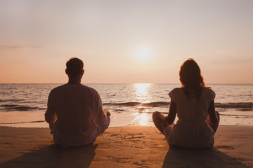 yoga and meditation in Goa, silhouette of man and woman at sunset, India