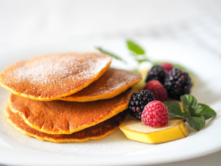 Pumpkin pancakes with raspberries mint and blackberries