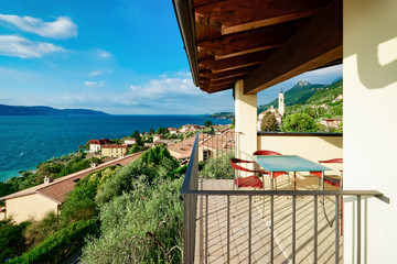 Terrace with table and chairs with view on Garda Lake in Italy