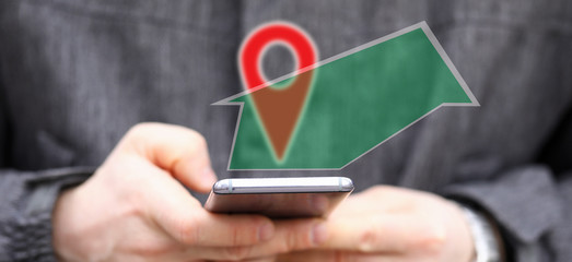 Man holding in hands smartphone while using navigation software