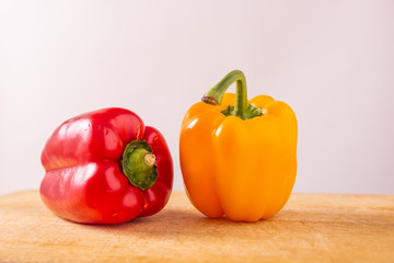 Red and yellow fresh sweet peppers on white background. Healthy ingredients, summer food