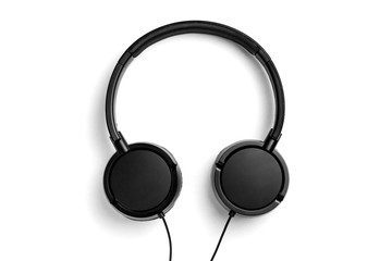 Black headphones isolated on white background. Flat lay top view copy space. Music concept. Minimal style. Black and white photo