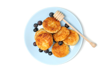 Plate with cheese pancakes and blueberry isolated on white background