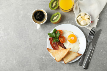 Delicious breakfast or lunch with fried eggs on grey background, top view