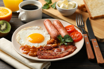 Delicious breakfast or lunch with fried eggs on wooden background, close up