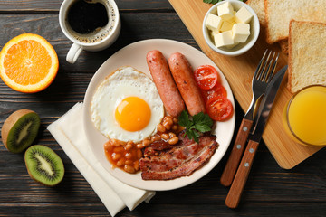 Fototapeta na wymiar Delicious breakfast or lunch with fried eggs on wooden background, top view
