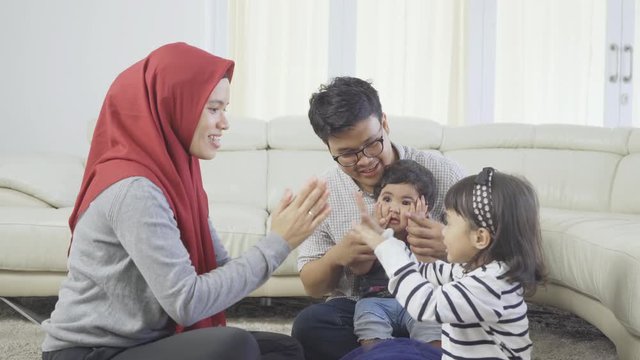 Happy muslim family playing together while sitting in the living room at home. Shot in 4k resolution