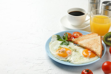 Delicious breakfast or lunch with fried eggs on white background, space for text