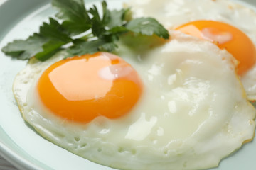 Plate with fried eggs on whole background, close up