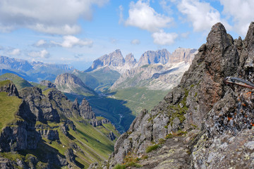 Fototapeta na wymiar View of mountain peaks and ridges as seen from via ferrata Delle Trincee, Padon Ridge, Dolomites mountains, Italy. Concept for Summer adventure activities in nature.