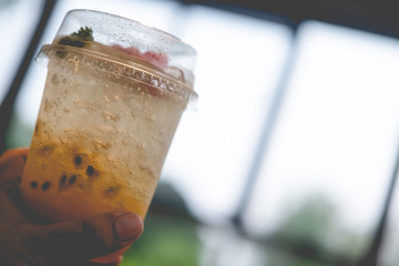 Close up a glass of fresh passion fruit juice mix with soda.