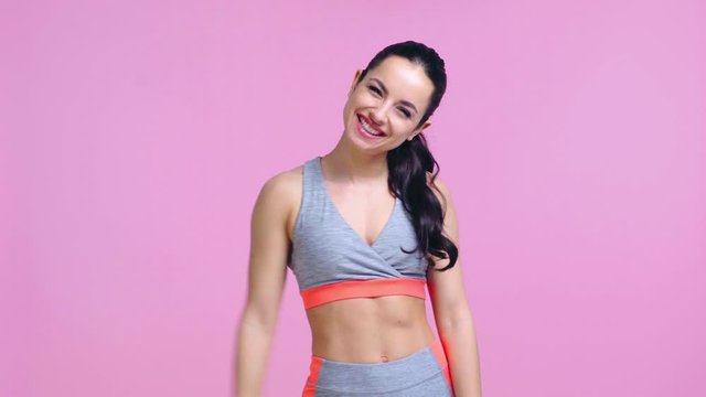 happy and sportive girl isolated on pink