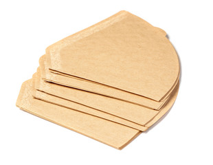 Several paper coffee filters for coffee makers isolated on a white background.