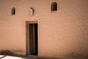 Open door in an adobe wall typical of Arabia