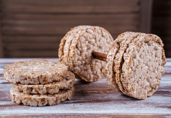 fitness Breakfast in the form of a dumbbell of useful multi -slag loaves on a wooden table. nutrition concept for fitness and health