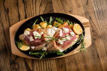 Sea bream stuffed with cream cheese and smoked ham with young potatoes and leek
