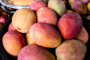 mango fruits in a basket at traditional marketplace