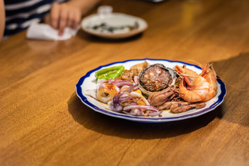 eat plate of seafood on table
