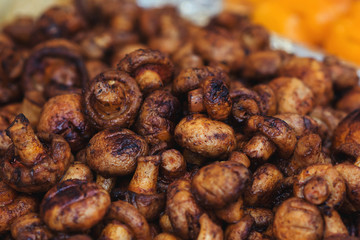 Grilled champignon mushrooms. Food background. Street food concept. Grilled vegetables at street food festival. Street market.
