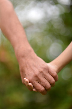 Portrait of a person holding granddaughter's hand