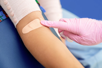 Nurse disinfecting arm skin.