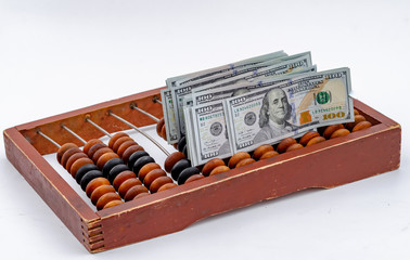 Paper money dollars on vintage wooden abacus background