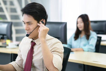 Call center operator agent in a headset with microphone consulting client online close up, Focus on the face