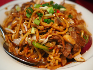 Classical Chinese Far East Asian fried noodles with beef peppers and onions