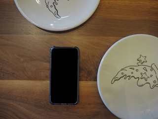 mobile phone on the table with plate