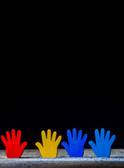 Colorfull puzzles hands on black background. World Autism Awareness Day Concept