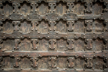 Fragment of the ancient wooden gate of the Church of St. Anastasia in Verona, Veneto, Italy