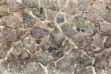 Textured surface made of rough gray stone. Background.