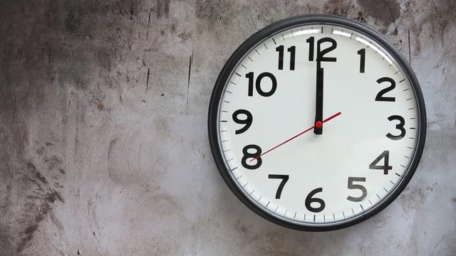 A Office Clock on a Wall with the Time of 12:00