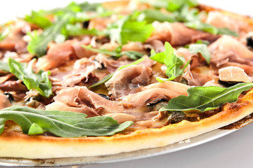 Pizza with Dried Tomatoes, Capers, Prosciutto, Arugula and Mozzarella