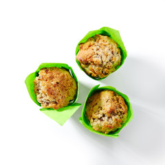 Three Muffins or Cupcakes in Green Paper Isolated