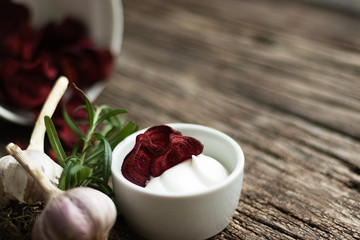Beetroot Chips. Useful handmade vegetable snack. In a dish are pieces of root vegetables. Garlic, rosemary and sauce in a dish bowl. Soft focus